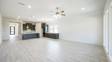 Kitchen featuring open floor plan, light countert