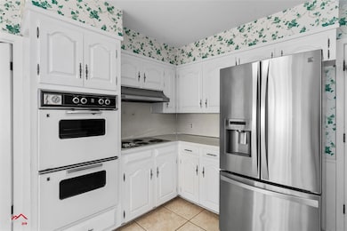 Kitchen featuring light tile patterned flooring, d