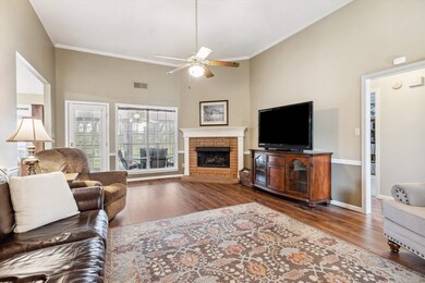 Living area with visible vents, wood finished floo