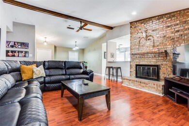 Living room featuring a fireplace, ceiling fan, br