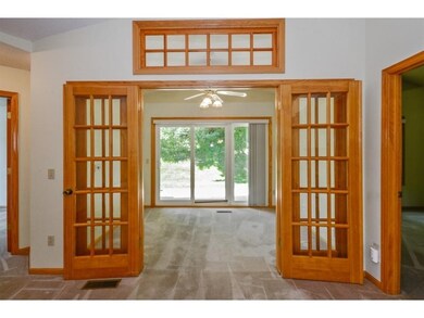 Framed by French doors and capped with a transom w