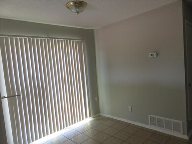 Spare room featuring light tile floors and a textured ceiling