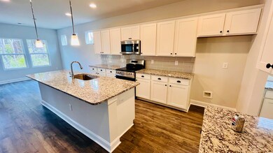 Kitchen featuring pendant lighting, sink, white ca