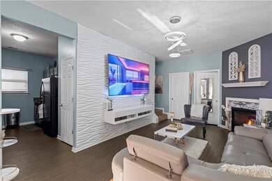 Living area featuring an accent wall, a fireplace,