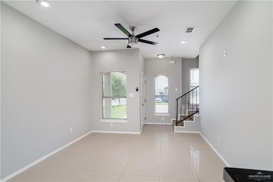 Foyer featuring a ceiling fan, stairway, light tile patterned floors, baseboards, and recessed lighting