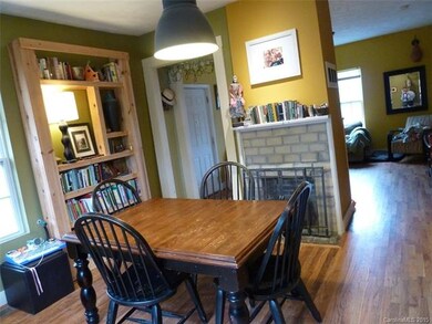 Dining room with hardwood floors and gas logs.