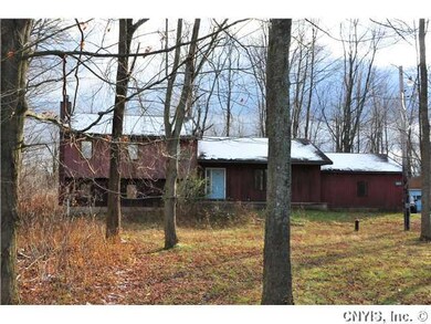 Exterior Front. Partially wooded setting, some cle