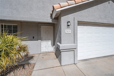 Doorway to property featuring a garage