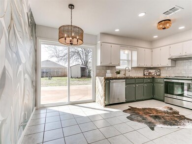 Kitchen featuring light tile floors, stainless ste