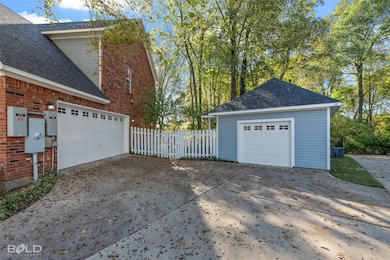 Garage with driveway, Blue building is shop.