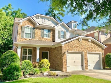 Craftsman-style house with a garage, concrete driveway, and stone siding