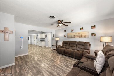 Living room with baseboards, visible vents, a ceil