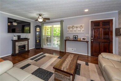 Living room with visible vents, baseboards, a ceil