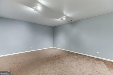 Carpeted empty room with baseboards