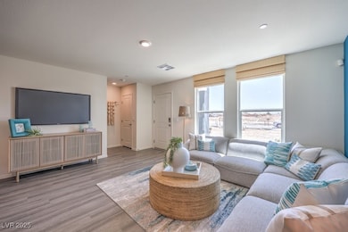 Living room with wood finished floors and recessed