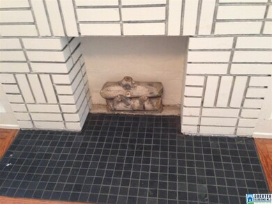 The beautiful brick design and tile hearth really 