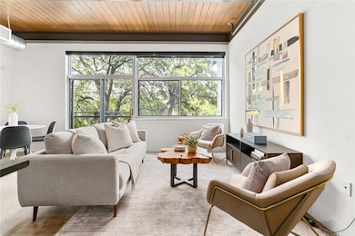Living area with wooden ceiling and baseboards
