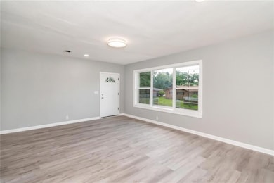 Spare room featuring light wood-style floors, baseboards, and recessed lighting