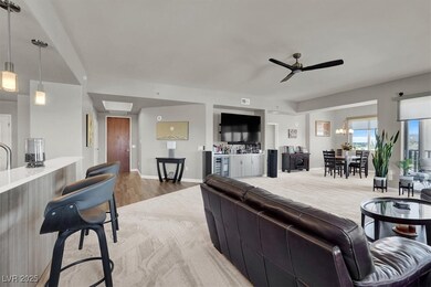 Living area with ceiling fan and light wood finish