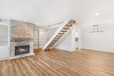 Beautiful brick fireplace next to built-ins functi