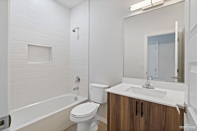 Bathroom with toilet,  shower combination, and vanity