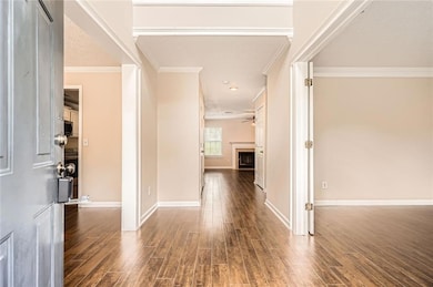 Foyer entrance featuring ornamental molding, wood 