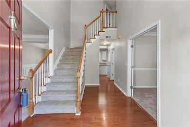Foyer featuring visible vents, baseboards, stairwa