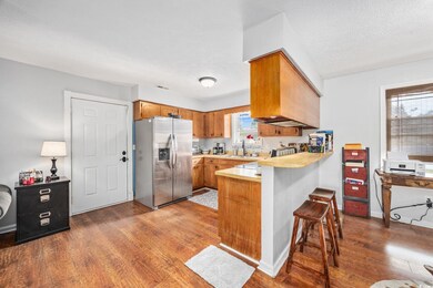 Kitchen featuring brown cabinetry, stainless steel