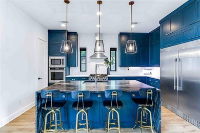 Kitchen with a kitchen bar, built in appliances, a