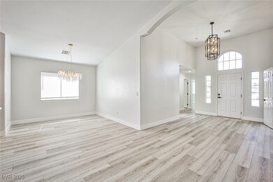 Entryway featuring a chandelier, light wood-type f