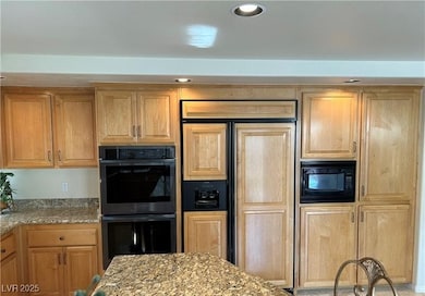 Kitchen with built in appliances, light stone coun