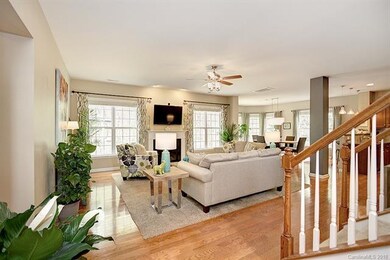 The great room boasts a gas log fireplace & beautiful hardwood floors