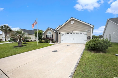 Ranch-style house featuring driveway, an attached garage, and a front yard