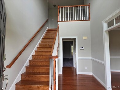 Stairway featuring a high ceiling, baseboards, and