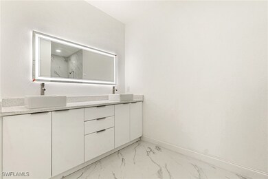 Bathroom with marble finish floors, double vanity,