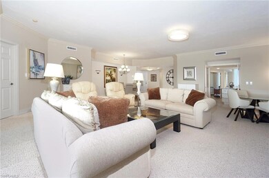 Living room featuring ornamental molding, light co