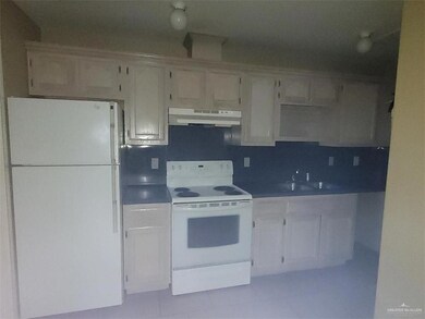 Kitchen with sink and white appliances