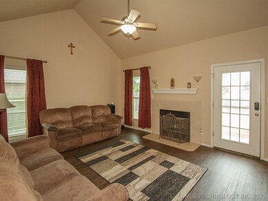 Living room has laminate wood flooring and wood bu