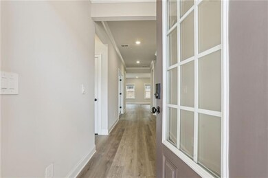 Hallway with recessed lighting, wood finished floo