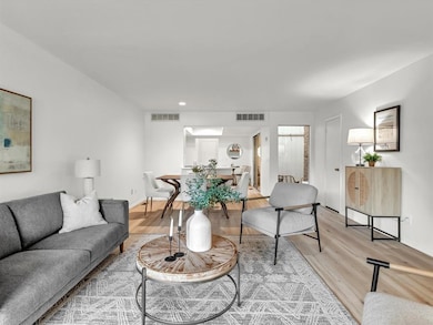 Living area featuring light wood-style flooring and recessed lighting