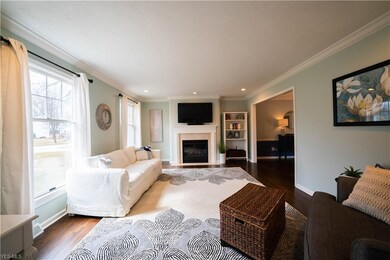 Spacious living room with gas fireplace, refinishe