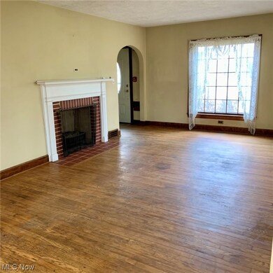 Unfurnished living room with dark hardwood / wood-style floors and a fireplace