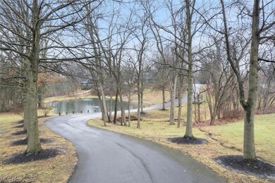 View of driveway featuring pond view