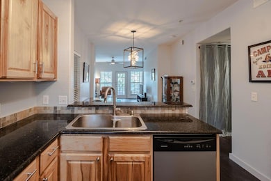 Kitchen featuring dishwasher, a peninsula, light 