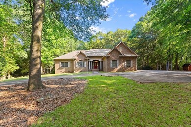 Ranch-style home with brick siding, a front yard, and crawl space