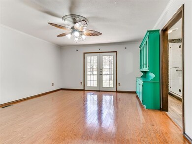Spare room featuring light wood-type flooring, orn