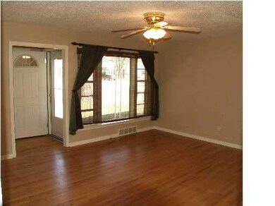 Spacious livingroom with hard wood floors.