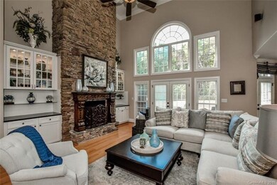 Two story great room features a stately gas firepl