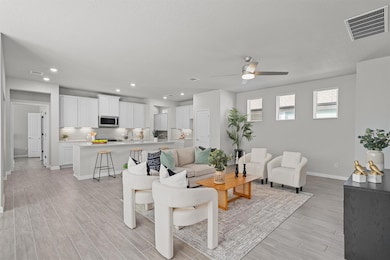 Living area featuring light wood-style floors, ba