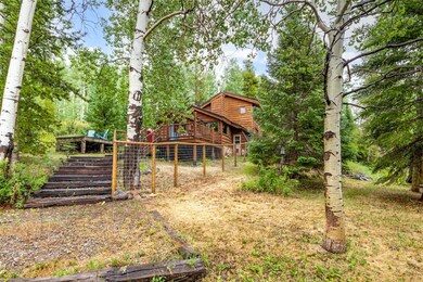 View of cabin and fenced dog run